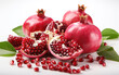 Fresh ripe pomegranates with leaves and pieces of pomegranate with delicious seeds isolated on a white background. High quality for advertising and promotions