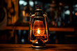 © Wazir Design - Vintage kerosene lamp on wooden table in dark room.
