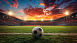 An empty professional soccer stadium from a low wide angle with a soccer ball centered in the foreground at sunset sunrise. Room for copy and text. 