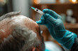 Senior man with hair loss problem receiving injection.