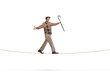 Full length shot of an elderly gentleman holding a cane and walking on a rope