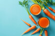 Carrot and glass of fresh juice on blue background 