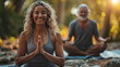 © IC Production - Outdoor yoga. Happy positive fit couple practicing partner yoga on open fresh air outside. Couple persons practice yoga outdoor. Zen concept. Yoga concept. Healthcare concept.