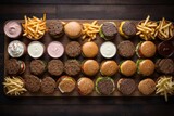 Fototapeta Nowy Jork - top view of fast food hamburger, french fries and other junk food on table