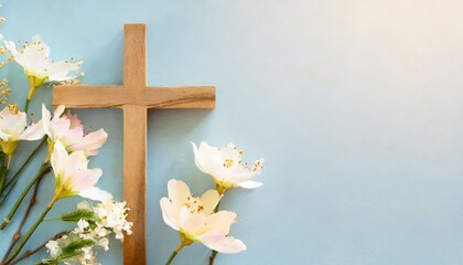 wooden cross with spring flowers on blue background with copy space religion background religious church holidays christianity feast easter palm sunday christening church wedding flat lay