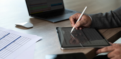 Poster - businessman uses a pen Signing The Digital Contract On Tablet