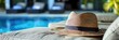 Summer relaxation,with a straw hat casually resting on a comfortable beach chair The setting evokes a sense of tranquility and leisure,inviting the viewer