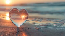 Glass Heart On Sand Ocean Side With Dawn Daylight
