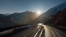 A series of hairpin turns on the mountain road made even more daunting by the blinding sun on the horizon and the risk of avalanches. . AI generation.