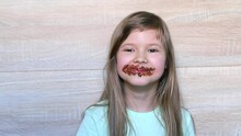 Laughing Little Girl Eating Chocolate Dirty Face