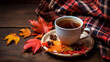 Autumn leaves and a cup of coffee with plaid on old coffee