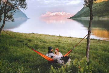 Wall Mural - happy couple chilling in hammock camping outdoor man and woman traveling together family lifestyle s