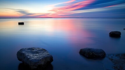 Wall Mural - lakeside at dusk, with the sky painted in hues of pink and blue as the sun sets