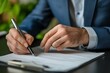 © Anastasiia - Signing a contract to seal a business deal: A businessman in a corporate meeting. Concept Business negotiation, Signing agreement, Corporate meeting, Business deal, Sealing contract