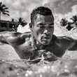 A Pacific Islander male in his 30s, engaging in a strenuous swim, his broad shoulders and toned body cutting through the water in an Olympic-sized pool. 
