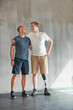 © peopleimages.com - Physiotherapist, hug and man with disability with healthcare and wellness professional with amputee. Exercise, physio and workout for health and support with physical therapy in studio with balance