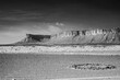 Infrared black and white photography of Sahara desert and Jbel Bani mountains on a way to Foumz Guid in Morocco. 850 nm filter. Rocky circle