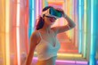 Young happy Asian woman wearing VR glasses on neon background