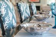 elegant table with silver shell bowls, coralprint chair covers, and blue stemware