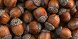 Hazelnuts on a pile close up. Texture of dried brown nuts.  Food ingredient hazelnuts Background, macro.