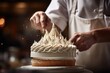 A close-up of a pastry chef piping cream onto a cake.