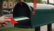 Close-up of person putting on letters with flag United Arab Emirates in mailbox