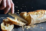 Fototapeta Desenie - person slicing a crusty baguette, crumbs scattering