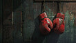 Red boxing gloves hanging on a wooden wall