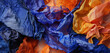 : A photograph of a unique abstract composition, where palette painting is heavily integrated with textiles in shades of cobalt blue and tangerine.
