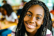 © Tixel - Close-up of a teenage girl with braids smiling radiantly in an educational setting