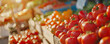 Red tomatoes on display at a sunny farmer's market. Fresh produce and healthy lifestyle concept. Design food blog visuals, and healthy diet promotions. Banner with copy space.