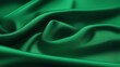 a green silk satin fabric textured with silky folds and folds