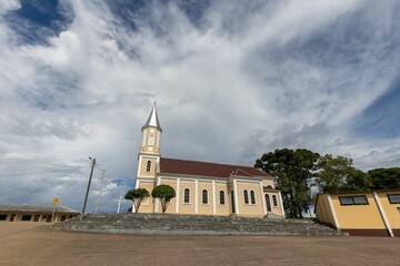 Picturesque church featuring a tall spire against a partly cloudy sky