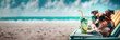 Fun dog with sunglasses sipping a fresh cocktail drink on a lounge chair at the beach, panoramic header, summer travel and relaxation with a pet