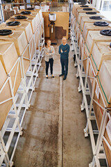 Poster - Woman, man and portrait in warehouse or packaging distribution with teamwork, wholesale or storage. People, face and factory floor for stock inventory with logistics career, production or shipment