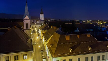 Wall Mural - Church of St. Mark day to night transition timelapse and parliament building Zagreb, Croatia. Top view from Kula Lotrscak tower viewpoint after sunset