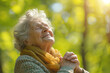 Joyful senior woman enjoying sunlight in nature