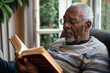 Senior man reading a book while relaxing at home	