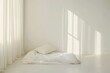 © JJ1990 - Minimalist bedroom with white bedding and sheer curtains with sunlight