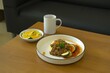 Breakfast menu with mashed potato, stir-fry ground beef and vegetables on white plate. Plate on wooden background