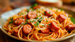 spaghetti with sausages on a plate. selective focus.