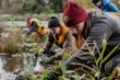A group of people picking up plants in a swamp to restore the wetland habitat for migratory birds