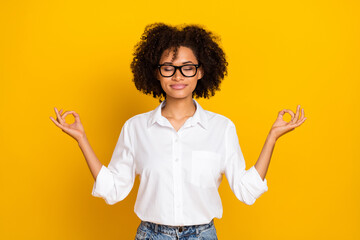 Poster - Portrait of attractive dreamy trendy wavy-haired girl meditating hobby isolated over bright yellow color background