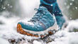 a pair of blue and white sneakers that has snow on them
