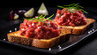 Beef tartare with onion and rosemary on toasted bread