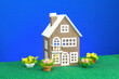 One low brown house with flowers around on a blue background
