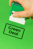 Fototapeta Zwierzęta - Official putting a stamp approving the Green Deal, Green background, vertical, copy space