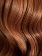 Extreme close-up shot of hair texture, with slight curves brunette with auburn highlights
