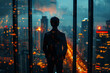 Silhouette of young man standing near the window on skyscraper and looking to the city under cloudy rain 