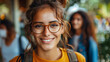© amixstudio - Portrait of a cheerful young woman with glasses, smiling at the camera, with people in the background.